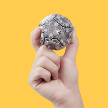 Load image into Gallery viewer, Hand holding magnetic Geode Sphere fidget toy