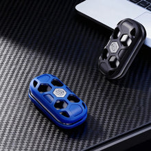 Charger l'image dans la galerie, Blue and black openwork metal fidget sliders on a desk beside a laptop