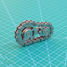 Load image into Gallery viewer, Spinner toy placed on an office desk as a meditation tool