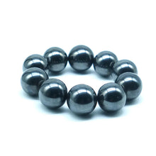 Load image into Gallery viewer, black magnetic ball bracelet arranged in circular shape on white background
