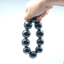 Load image into Gallery viewer, black magnetic balls forming stretchable bracelet ring shape
