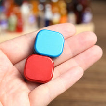 Laden Sie das Bild in den Galerie-Viewer, Blue and red mini metal fidget sliders shown in hand
